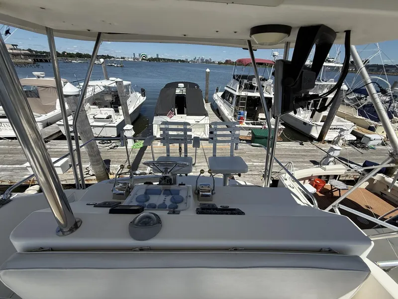 Slide: The Image of 1988 Ocean Yachts 35 Flybridge at marina, view from helm, overlooking docked boats and water. - 7