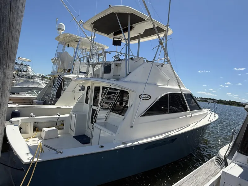 The Image of 1988 Ocean Yachts 35 Flybridge docked, showcasing sleek design and spacious deck. - 0