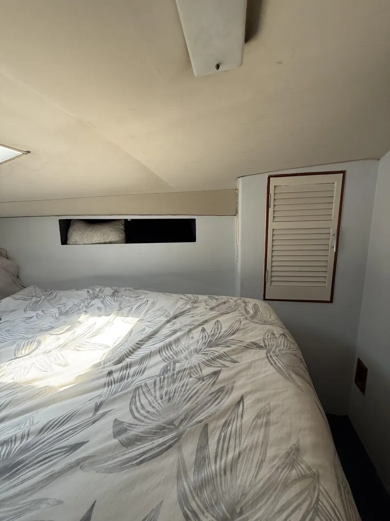 Slide: The Image of Cozy cabin interior of 1988 Ocean Yachts 35 Flybridge with floral bedding. - 17