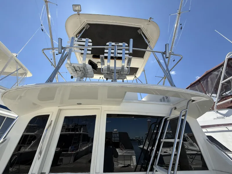 Slide: The Image of 1988 Ocean Yachts 35 Flybridge, showcasing upper deck and ladder under clear blue sky. - 4