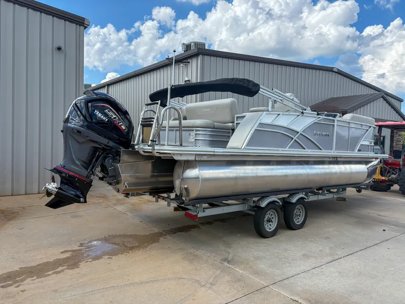 Slide: The Image of 2023 Sylvan Mirage 8522 pontoon boat with Yamaha engine on trailer, parked outside. - 3