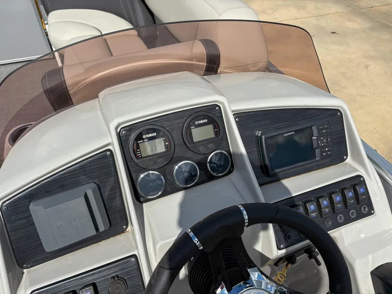 Slide: The Image of 2023 Sylvan Mirage 8522 dashboard with Yamaha gauges and Garmin navigation system. - 7