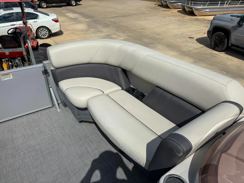 Slide: The Image of 2023 Sylvan Mirage 8522 pontoon boat with plush seating, parked outdoors. - 9