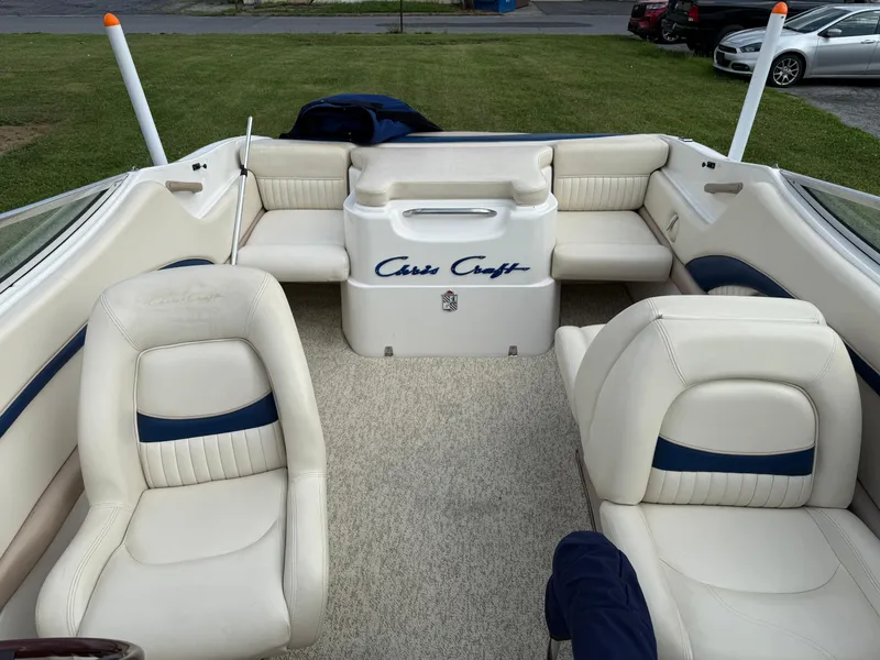 Slide: The Image of 1999 Chris-Craft 200 Bowrider SS interior with white leather seats and blue accents. - 13