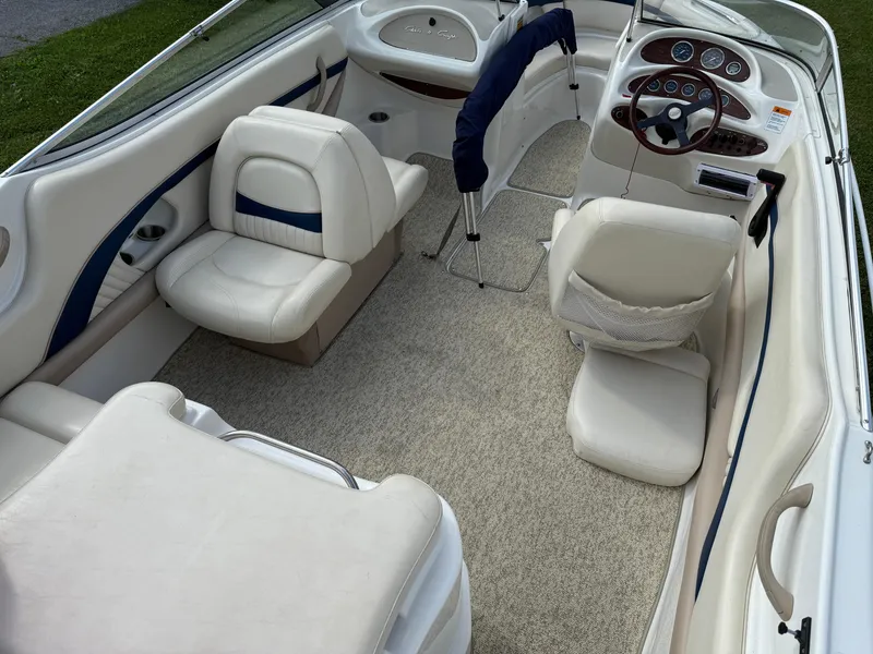 Slide: The Image of 1999 Chris-Craft 200 Bowrider SS interior with white seating and steering console. - 5