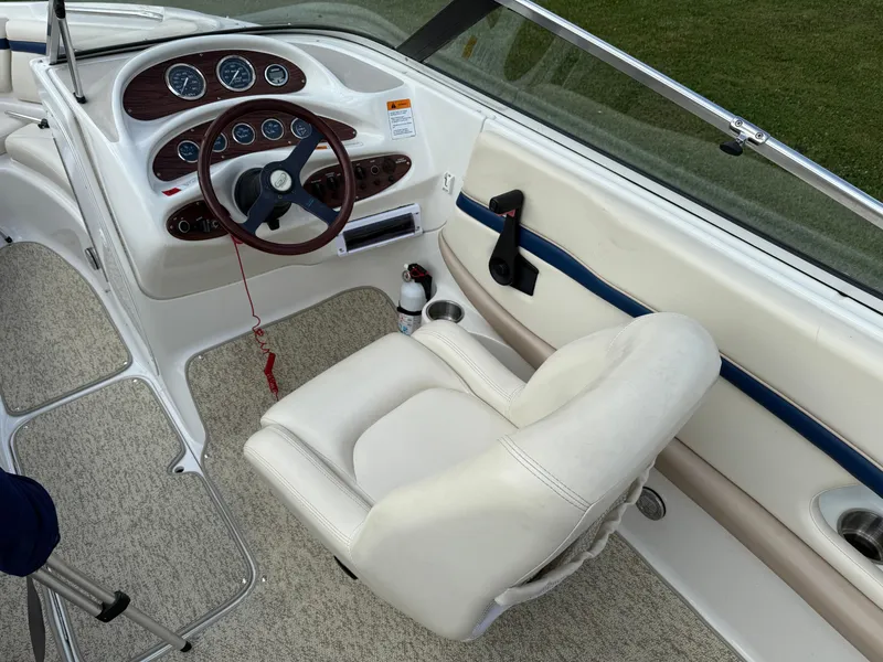 Slide: The Image of 1999 Chris-Craft 200 Bowrider SS cockpit with steering wheel and gauges. - 9