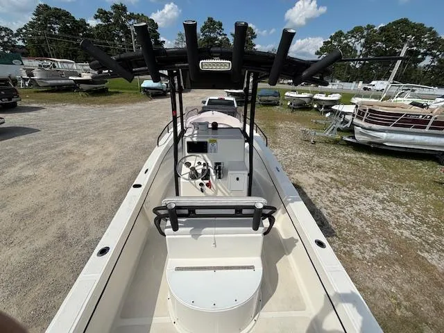 Slide: The Image of 2022 May-Craft 2300 CCX boat, center console, parked in a marina with other boats. - 10