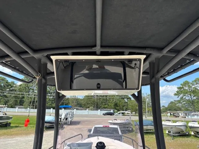 Slide: The Image of 2022 May-Craft 2300 CCX boat console with overhead storage and outdoor view. - 13