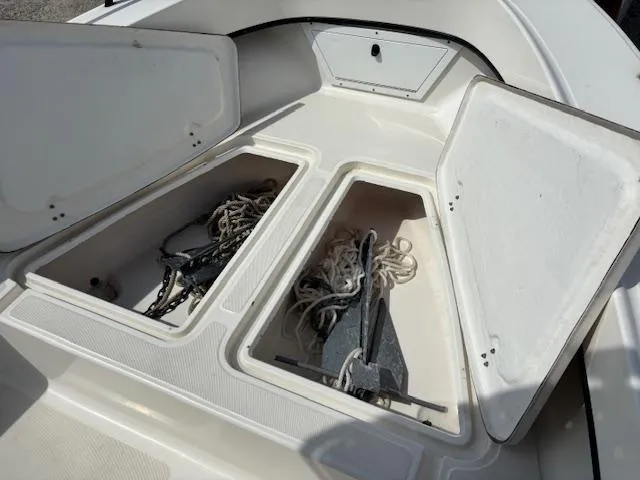 Slide: The Image of 2022 May-Craft 2300 CCX boat storage compartments with anchors and ropes. - 16