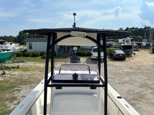 Slide: The Image of 2022 May-Craft 2300 CCX boat with T-top and console, parked in a marina. - 18