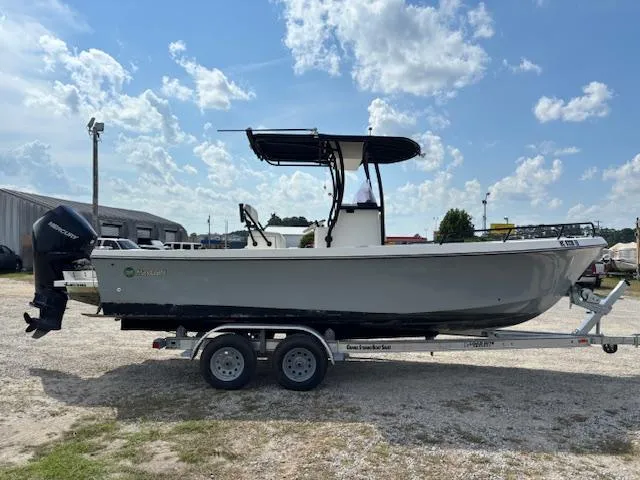 Slide: The Image of 2022 May-Craft 2300 CCX boat on trailer under a partly cloudy sky. - 4
