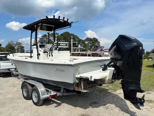 Slide: The Image of 2022 May-Craft 2300 CCX boat on trailer, featuring a powerful outboard motor. - 7