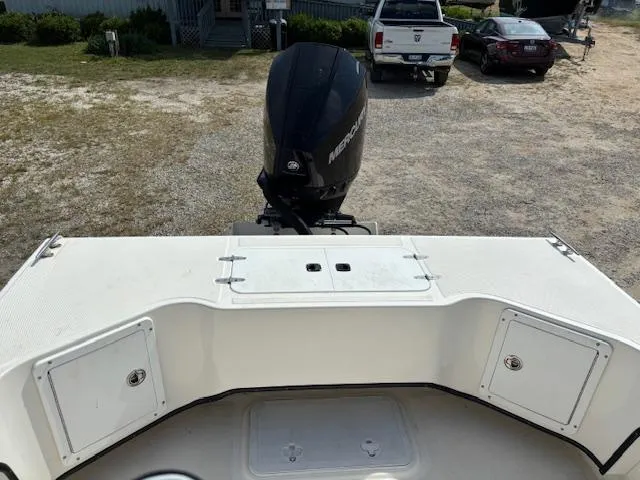 Slide: The Image of 2022 May-Craft 2300 CCX boat with Mercury outboard motor, parked on gravel. - 8