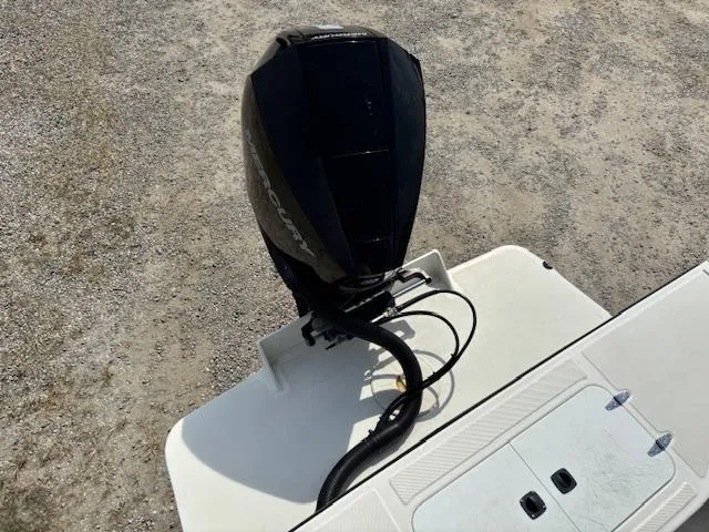 Slide: The Image of 2022 May-Craft 2300 CCX boat with outboard motor on gravel surface. - 9