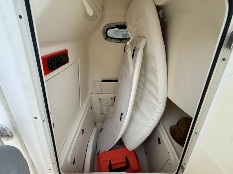 Slide: The Image of Interior cabin of 2005 Boston Whaler 270 Outrage with storage and cushions. - 22