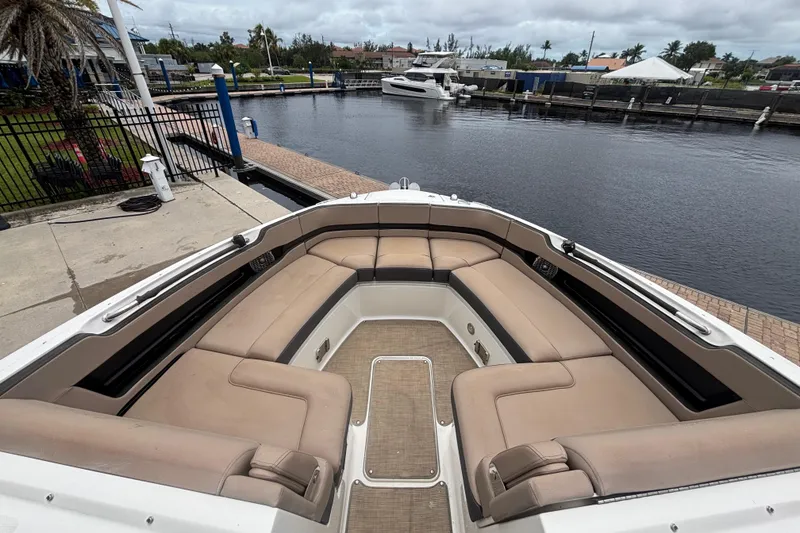 Slide: The Image of 2018 Sea Ray SLX 310 Outboard boat with spacious seating at a marina dock. - 11