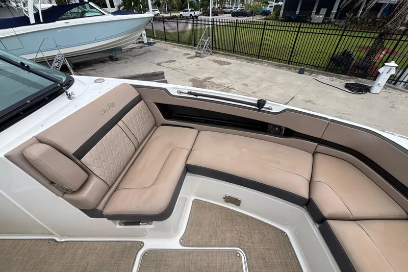 Slide: The Image of 2018 Sea Ray SLX 310 Outboard boat with beige seating and spacious deck area. - 13
