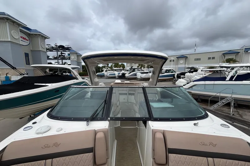 Slide: The Image of 2018 Sea Ray SLX 310 Outboard boat at marina, cloudy sky background. - 15