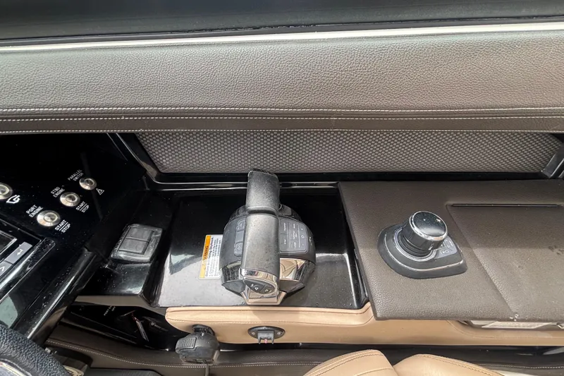 Slide: The Image of 2018 Sea Ray SLX 310 Outboard dashboard with controls and joystick. - 23