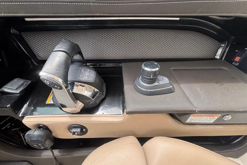 Slide: The Image of 2018 Sea Ray SLX 310 Outboard control panel with joystick and throttle. - 24