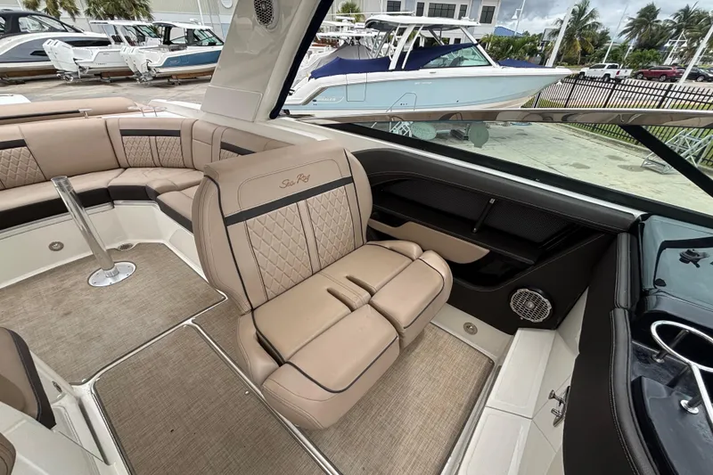Slide: The Image of Luxurious interior of 2018 Sea Ray SLX 310 Outboard with beige seating and modern design. - 26