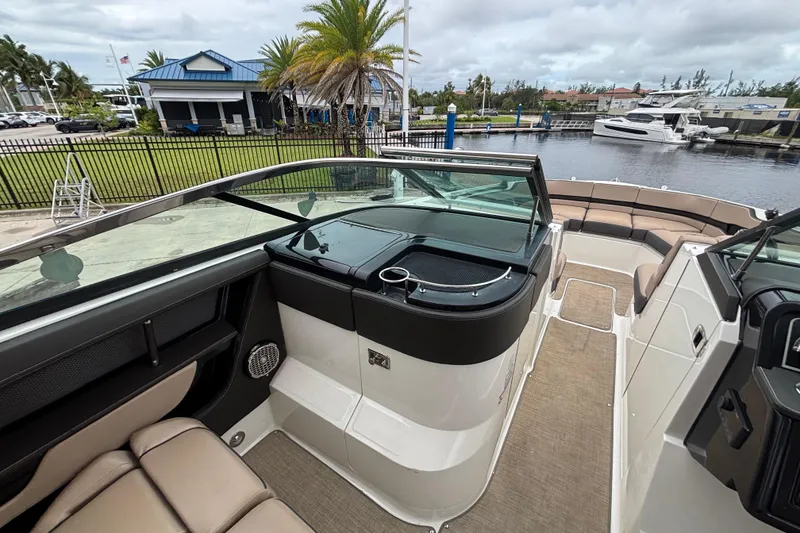 Slide: The Image of 2018 Sea Ray SLX 310 Outboard boat interior with seating and waterfront view. - 27