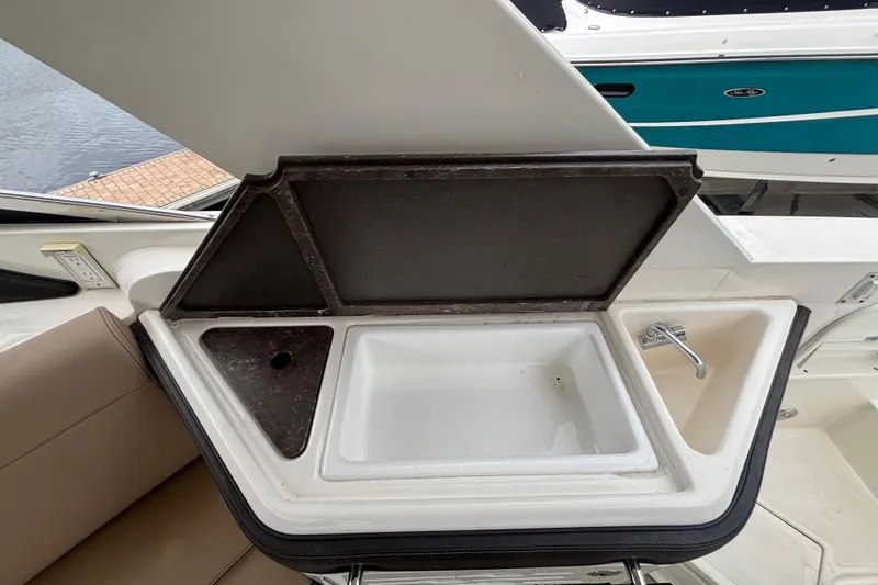 Slide: The Image of 2018 Sea Ray SLX 310 Outboard boat sink and storage compartment. - 34