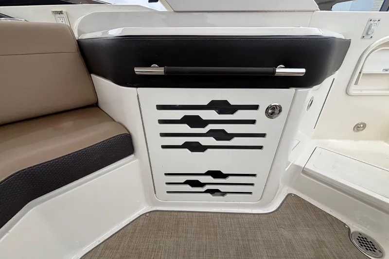 Slide: The Image of 2018 Sea Ray SLX 310 Outboard interior detail with seating and storage compartment. - 35
