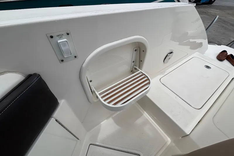 Slide: The Image of 2018 Sea Ray SLX 310 Outboard boat interior with hatch lift and step detail. - 38