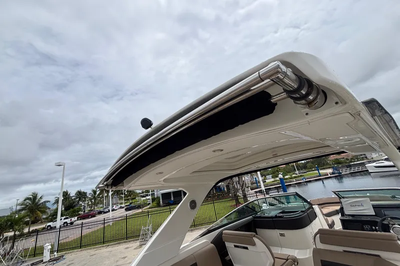 Slide: The Image of 2018 Sea Ray SLX 310 Outboard boat with sleek design, docked near a marina. - 39