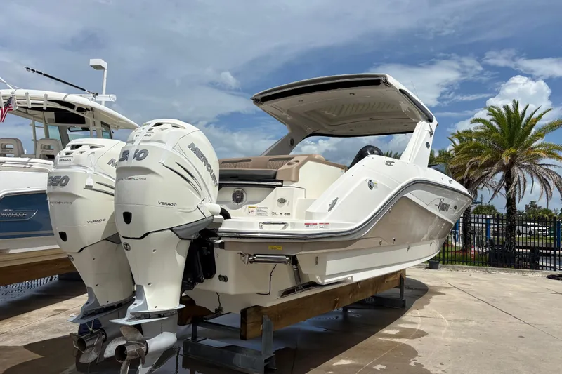 Slide: The Image of 2018 Sea Ray SLX 310 Outboard boat with twin Mercury engines on display. - 4