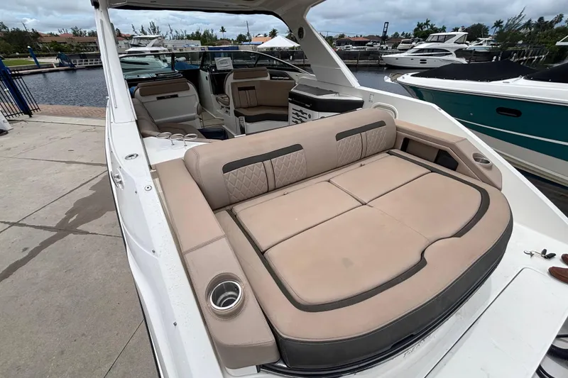 Slide: The Image of 2018 Sea Ray SLX 310 Outboard with spacious seating, docked at a marina. - 41