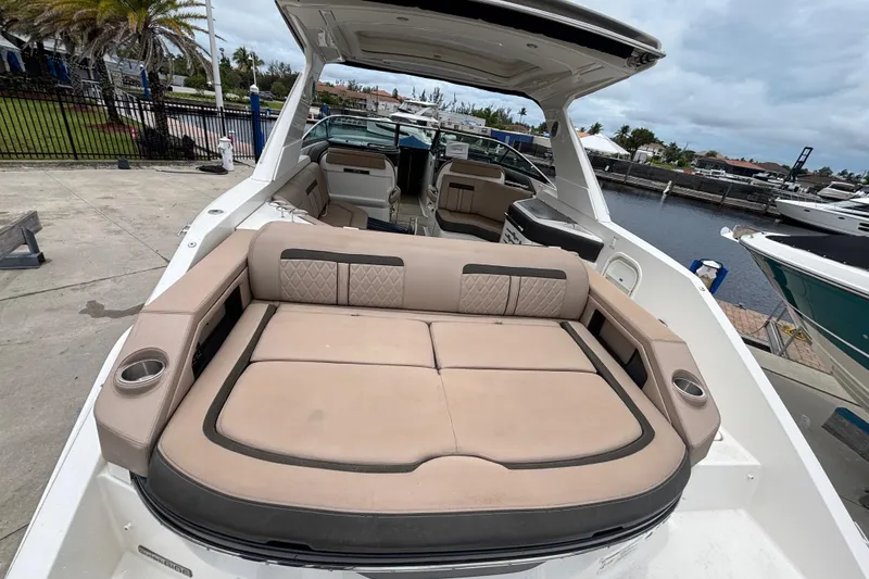 Slide: The Image of 2018 Sea Ray SLX 310 Outboard boat with spacious seating and luxurious interior at a marina. - 42