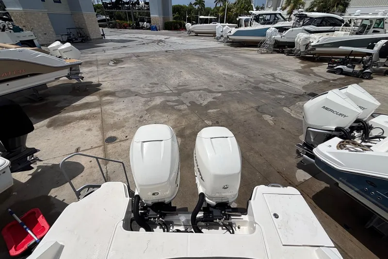 Slide: The Image of 2018 Sea Ray SLX 310 Outboard in a marina with other boats. - 43