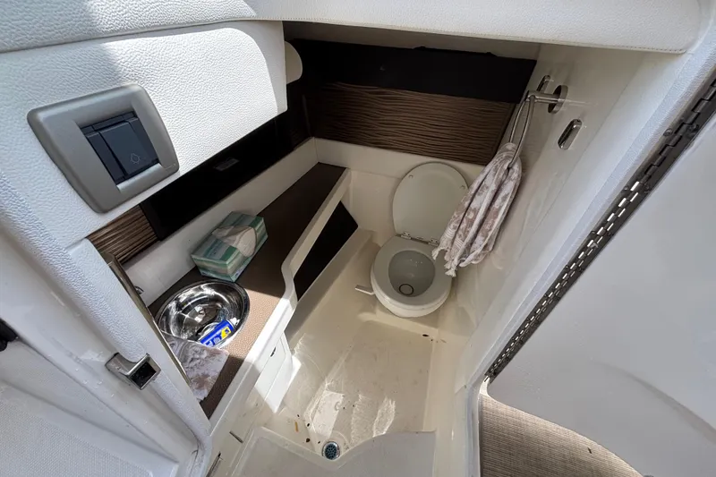 Slide: The Image of 2018 Sea Ray SLX 310 Outboard boat bathroom interior with toilet and sink. - 44