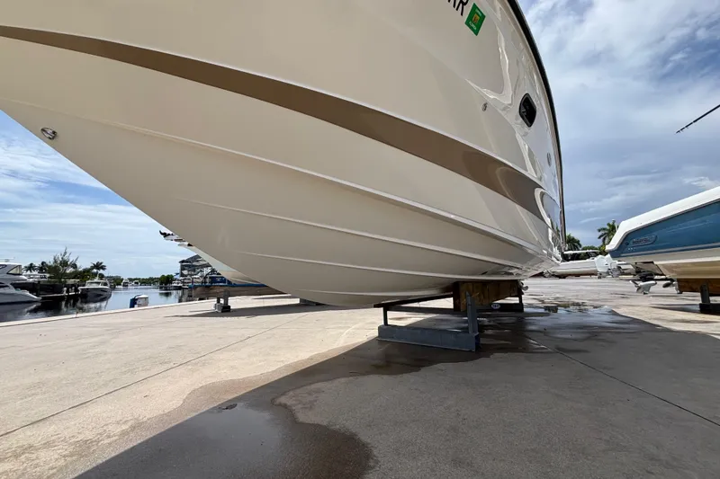 Slide: The Image of 2018 Sea Ray SLX 310 Outboard boat on dry dock, marina background. - 6