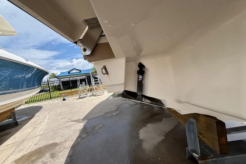 Slide: The Image of 2018 Sea Ray SLX 310 Outboard boat on trailer, showcasing hull and surroundings. - 9