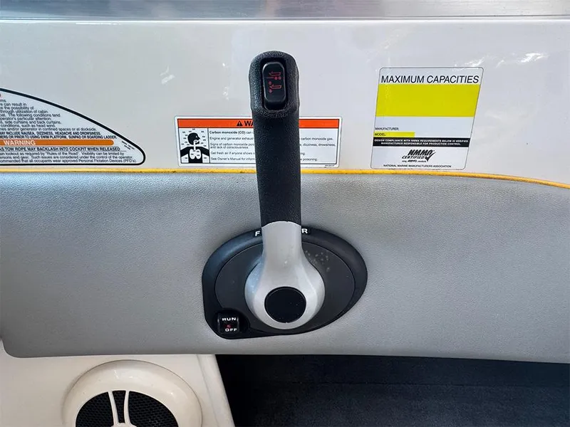 Slide: The Image of Throttle control of 2008 Sea Ray 185 Sport boat with warning labels and capacity information. - 11