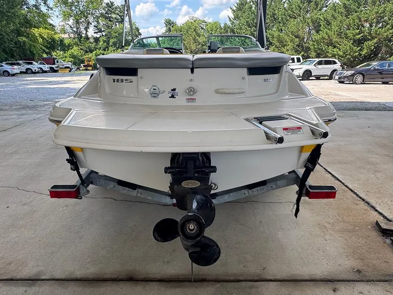 Slide: The Image of 2008 Sea Ray 185 Sport boat rear view with propeller, parked outdoors. - 2
