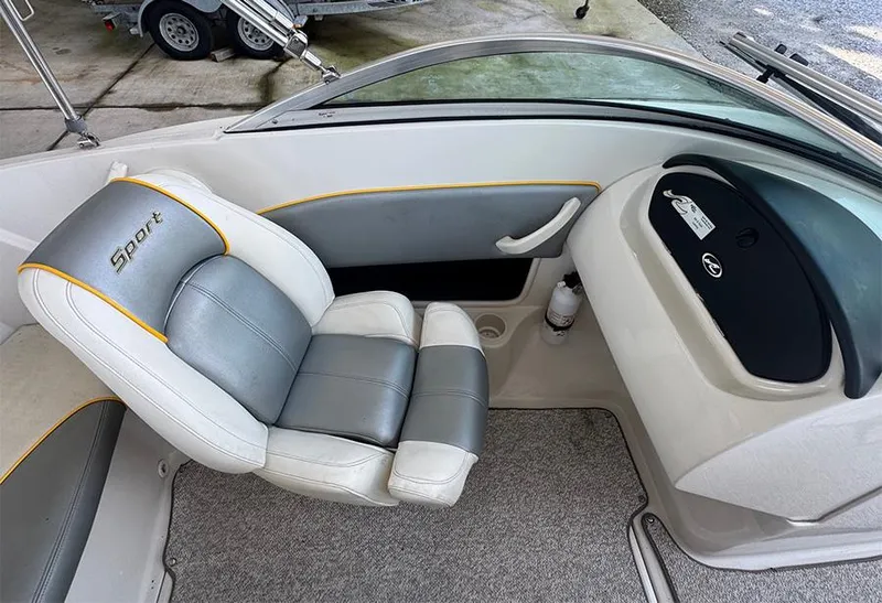 Slide: The Image of 2008 Sea Ray 185 Sport boat interior with gray and white seating. - 8