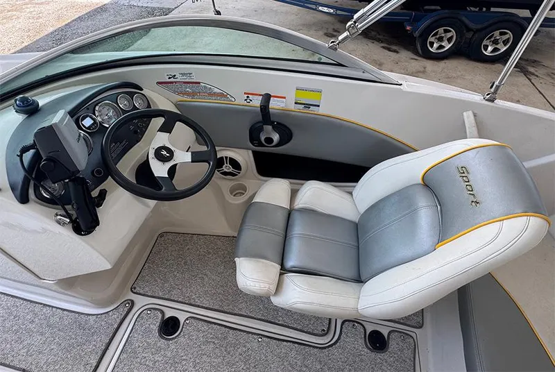 Slide: The Image of 2008 Sea Ray 185 Sport boat interior with steering wheel and cushioned seat. - 9