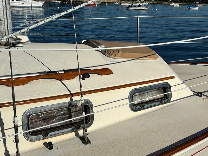 Slide: The Image of 1981 Sabre 30 sailboat deck with wooden trim and ocean view. - 3