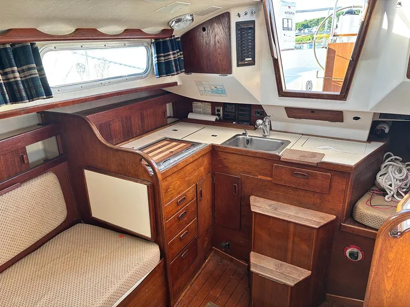 Slide: The Image of Interior of 1981 Sabre 30 sailboat with wooden cabinetry and compact kitchen area. - 7