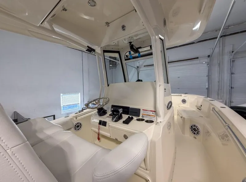 Slide: The Image of 2025 Cobia 265 Open Center Console interior with steering wheel and controls. - 10