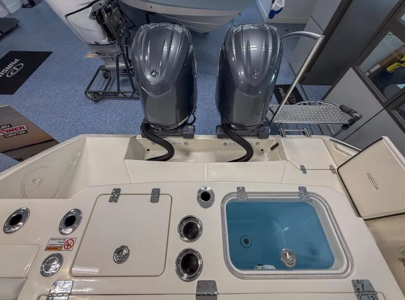 Slide: The Image of 2025 Cobia 265 Open Center Console with dual outboard engines and fishing amenities. - 14