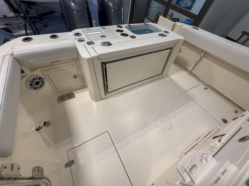 Slide: The Image of 2025 Cobia 265 Open Center Console boat interior with storage and seating. - 15