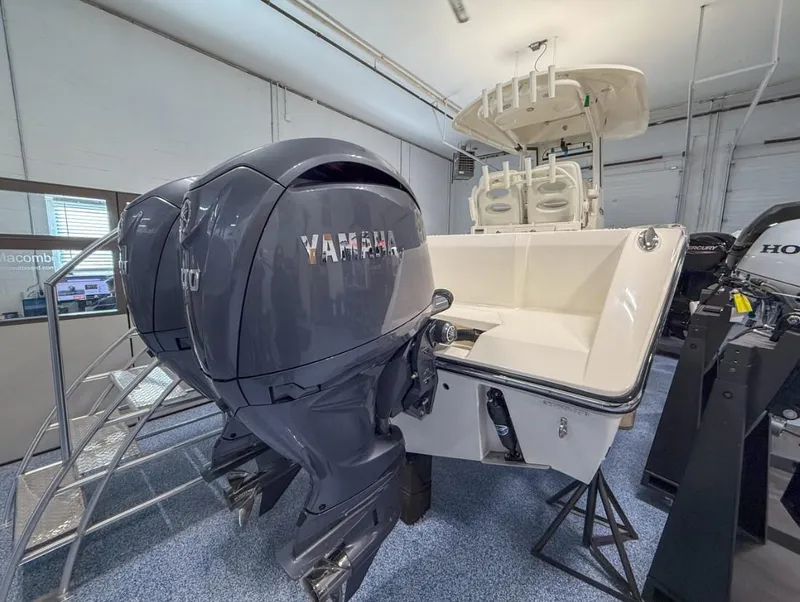 Slide: The Image of 2025 Cobia 265 Open Center Console with Yamaha outboard engines in showroom. - 5
