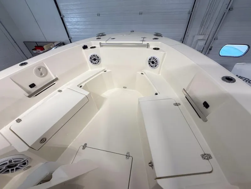 Slide: The Image of 2025 Cobia 265 Open Center Console boat interior with storage compartments and speakers. - 9