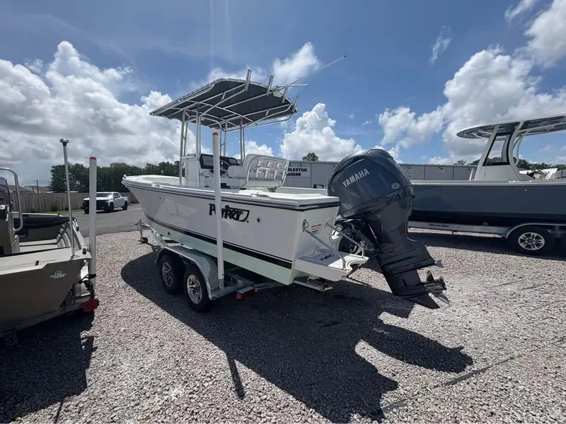 The Image of 2026 Parker 210 COASTAL boat with Yamaha engine on trailer, parked outdoors. - 1