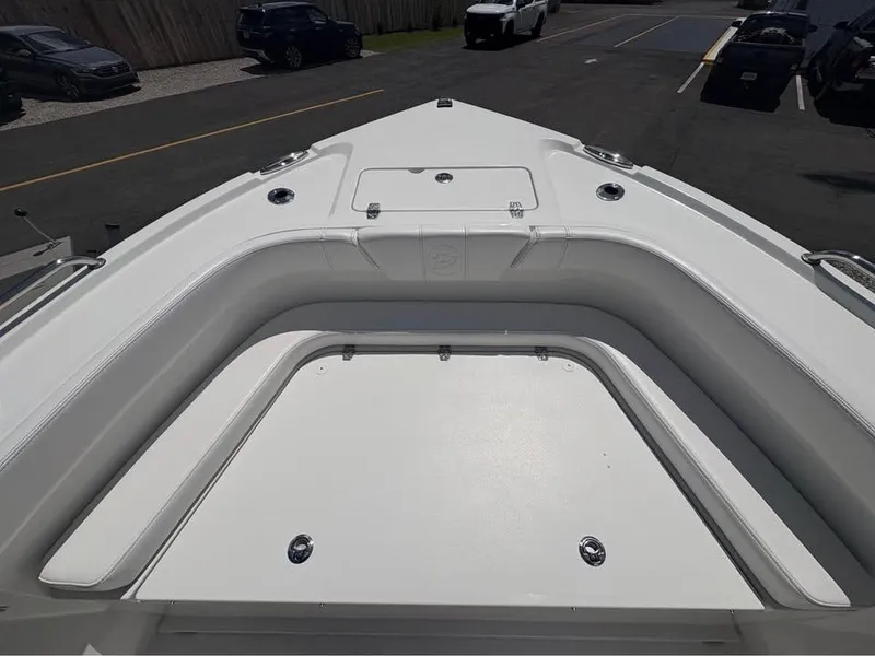 Slide: The Image of 2026 Parker 210 COASTAL boat deck, featuring sleek white seating and storage compartments. - 11